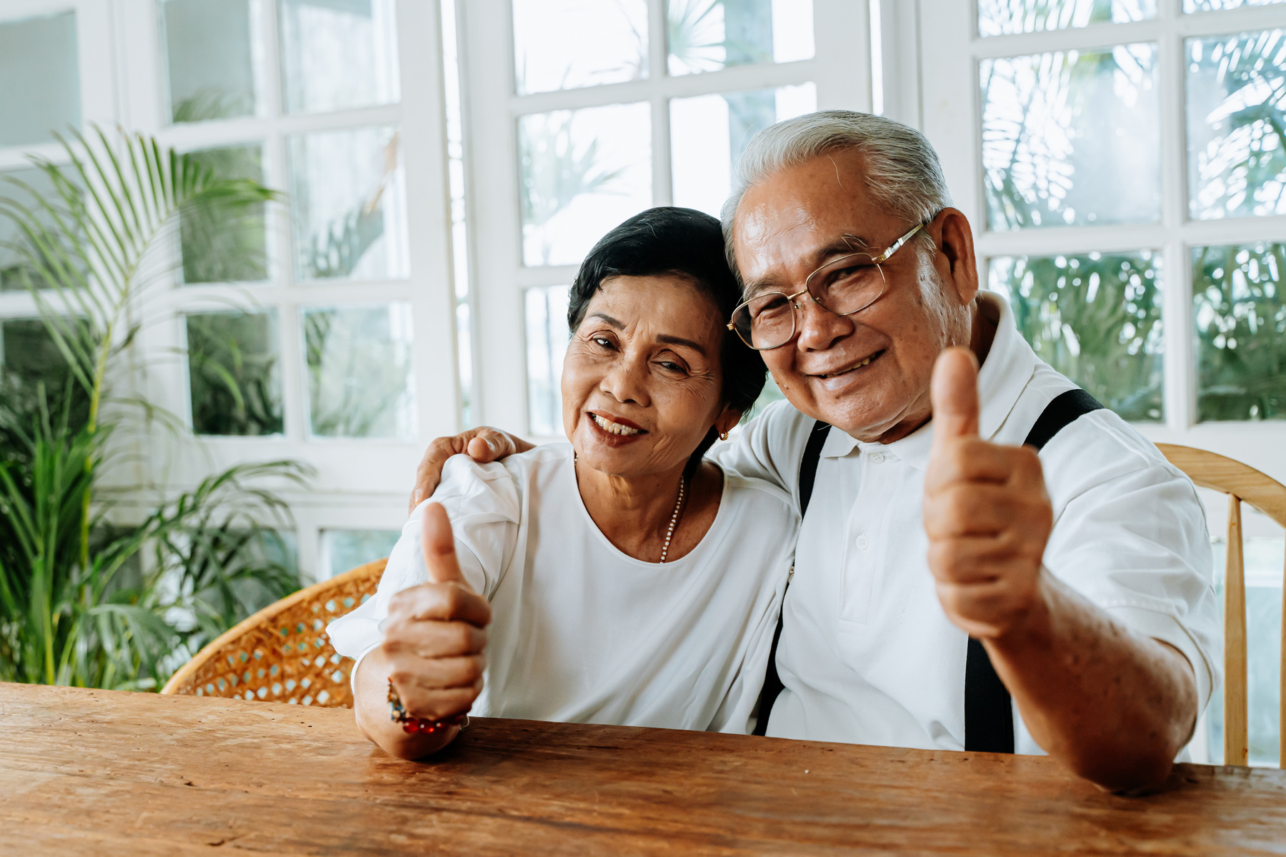 Elderly Couple Holding a Thumbs Up Sign